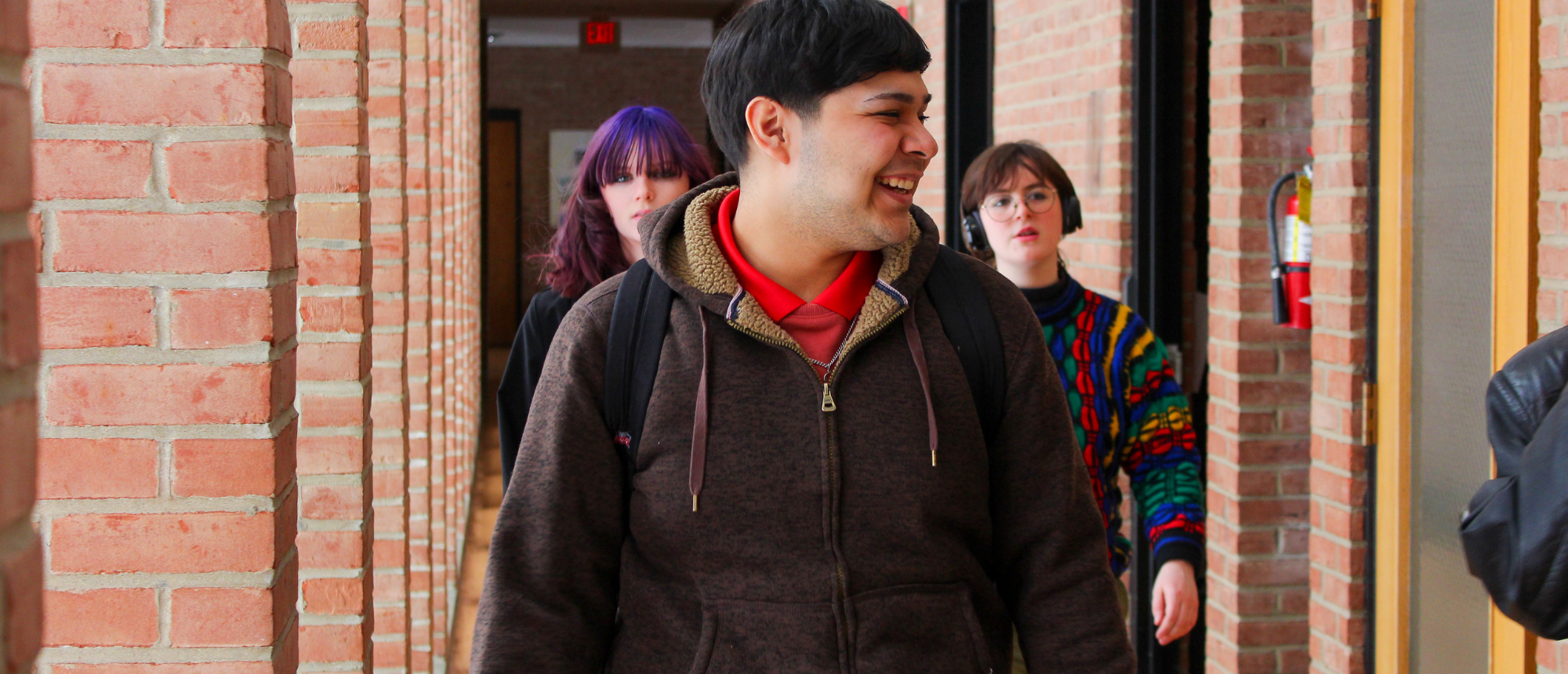 Students laughing and working together on campus